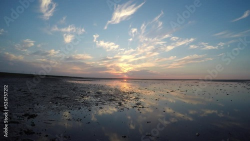 4K-Sunset on Wadden Sea with reflection in a water photo