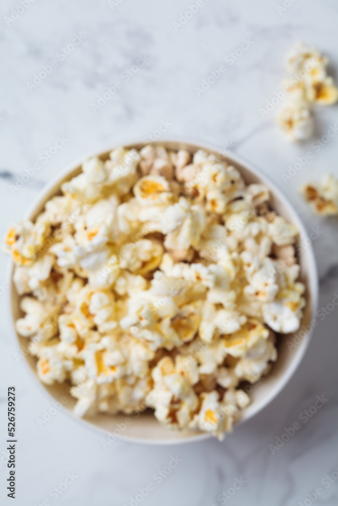 Blurred popcorn bowl background, defocus concept, top view. Snack for movie. Blurred popcorn bowl background, defocus concept, top view. Snack for movie.