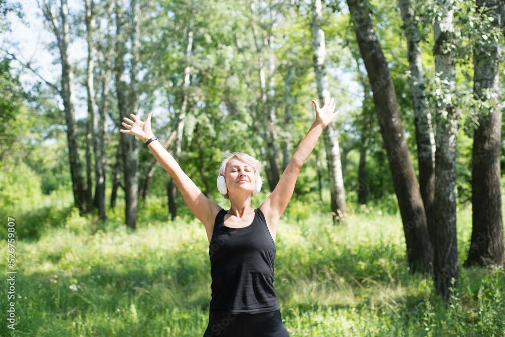 Sporty woman is raising her hands and smiling. Sporty lifestyle concept. Sporty woman is raising her hands and smiling. Sporty lifestyle concept.