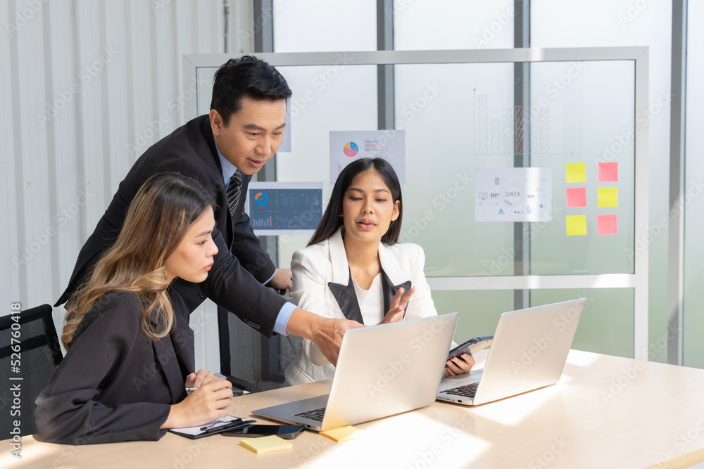 A group of young Asian businessmen Talking and planning work happily and have fun. at the company's office A group of young Asian businessmen Talking and planning work happily and have fun. at the company's office