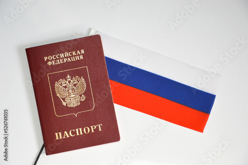 the flag of the Russian Federation and the passport of a Russian citizen on a white background.