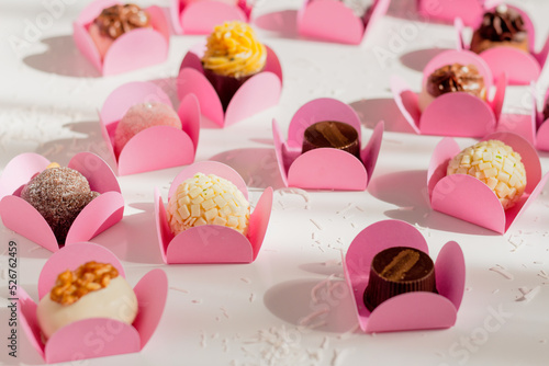 Candies on white background. Spring feminine composition. Food styling.