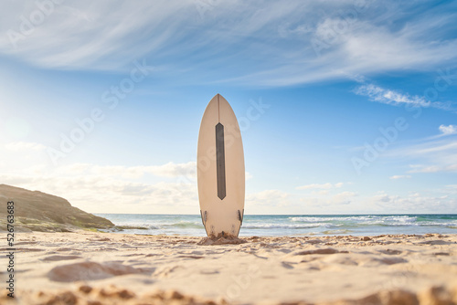 Surfboard for surfing staying on beach sand photo