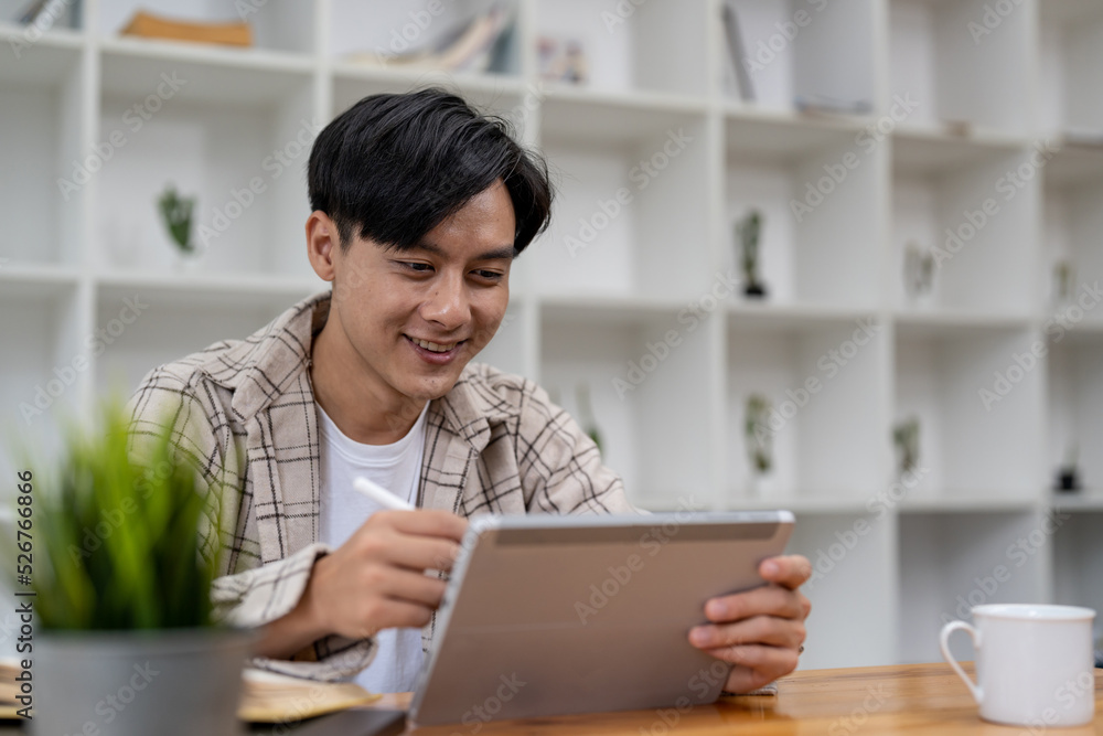Young asian student using digital tablet remote studying, watching online webinar, zoom virtual training on video call meeting. Young asian student using digital tablet remote studying, watching online webinar, zoom virtual training on video call meeting.
