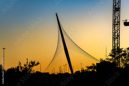 The Chords Bridge - light rail and pedestrian bridge at the entrance to Jerusalem. Bridge silhouette in sunset light.
