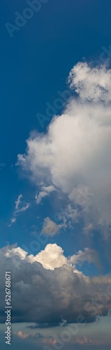 Fantastic thunderclouds at sunrise, vertical panorama