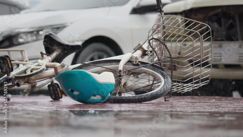 Bicycle helmet spinning and falling down bicycle on the road after traffic accident on a raining day