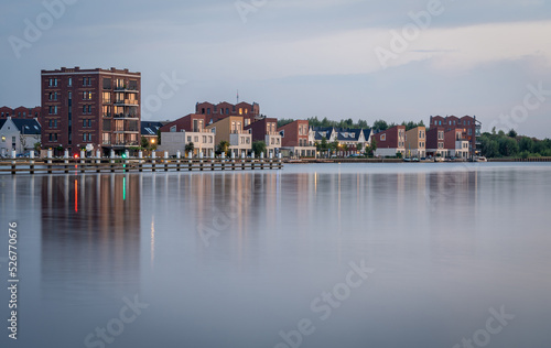 Modern residential neighbourhood along the lake in the village of Spaarndam by sunset © Milos