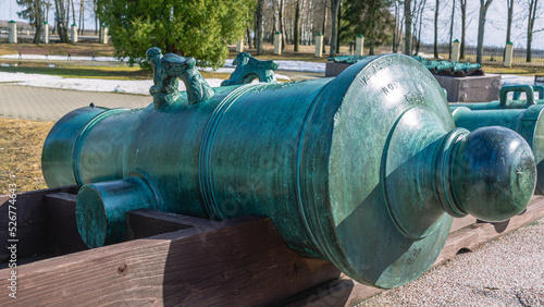 A bronze cannon that fired cannonballs. The barrel of a cannon made in the 18th century. An old army weapon that participated in the Battle of Borodino.