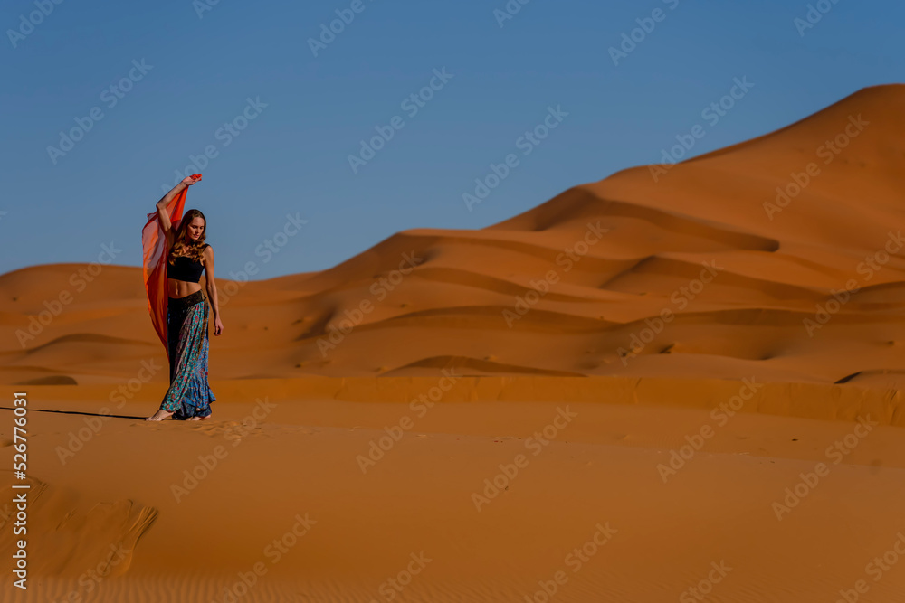 A Beautiful Model Poses In The Sand Dunes In The Great Sahara Desert In Morocco, Africa - obrazy, fototapety, plakaty 