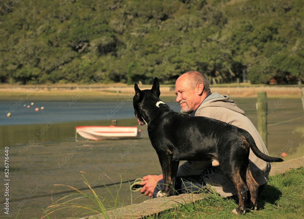 Senior man with his dog at water Senior man with his dog at water