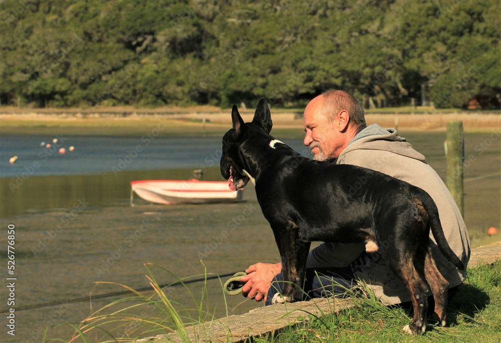 Senior man with his dog at water Senior man with his dog at water