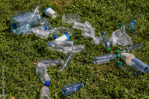 Canvas Print Close up on a pile of plastic bottles held by a young caucasian woman in a park,