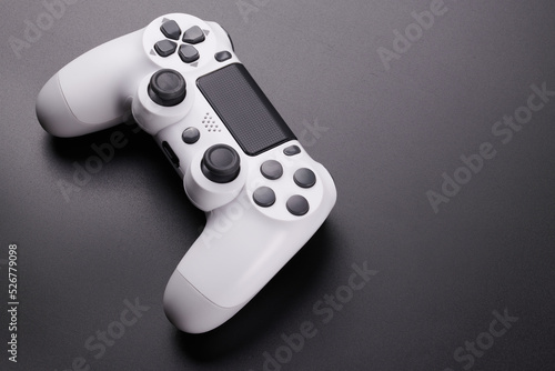 White video game controller, joystick for game console isolated on black background. Gamer control device close-up