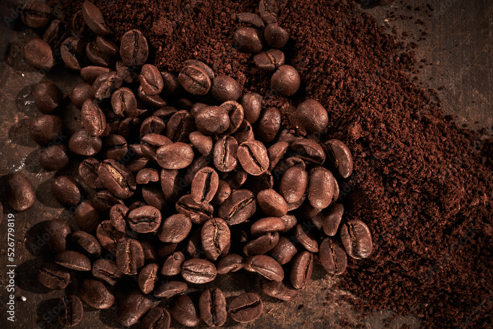 Roasted coffee beans different sort ground and whole isolated close up on brown grunge background Roasted coffee beans different sort ground and whole isolated close up on brown grunge background