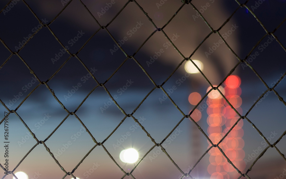 metal mesh fence in front of the factory