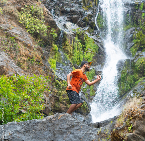 Tourist trying to jump in front of vibhooti water falls photo