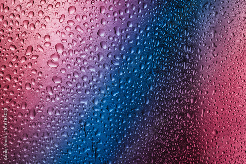 Water droplets on metal surfave with gradient colors