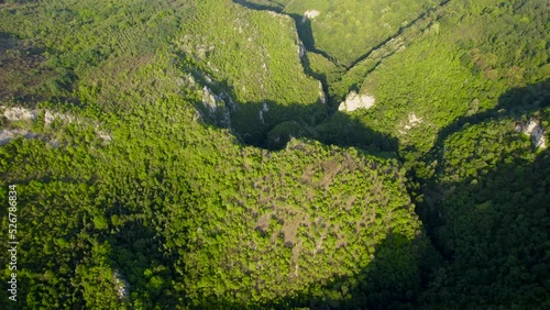 Aerial view of karst landscape, in Romania, with valleys and cliffs, at sunset. 