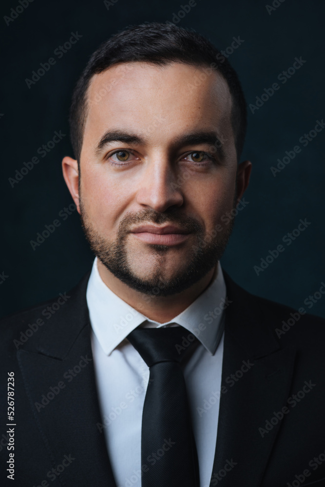 Close-up portrait of a modern man in a trendy suit, a man in a black suit on a dark background Close-up portrait of a modern man in a trendy suit, a man in a black suit on a dark background
