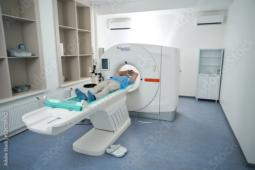 Man in the tomography room undergoes a diagnostic procedure