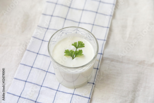 A glass of ayran on a light background linen towel photo