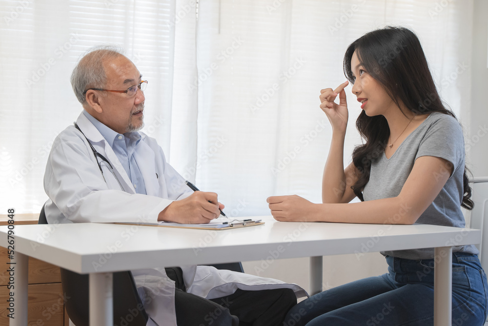 Close up doctor talking with the patient at a desk in the clinic Close up doctor talking with the patient at a desk in the clinic