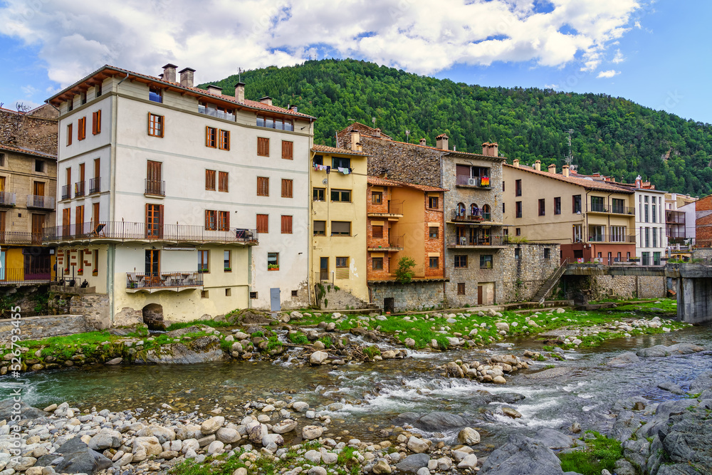 Houses on the banks of the river Ter as it passes through the picturesque town of Camprodon next to the mountains, Girona, Catalonia.