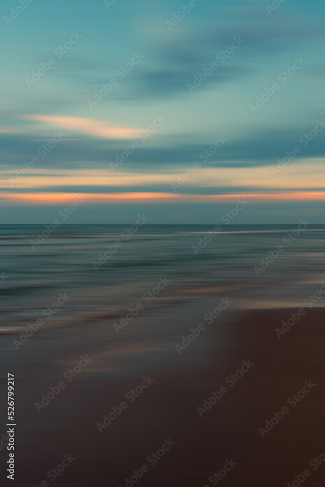 Beautiful sunset sky and ocean nature background with planning motion blur