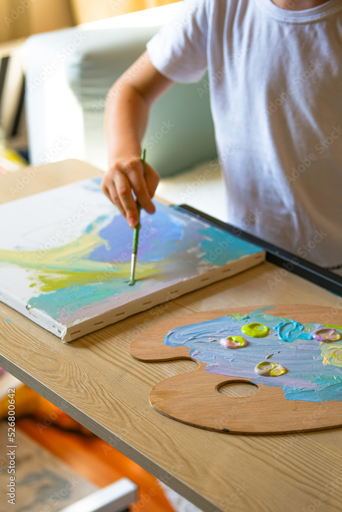 Child painting on canvas with acrilic paint. Child painting on canvas with acrilic paint.