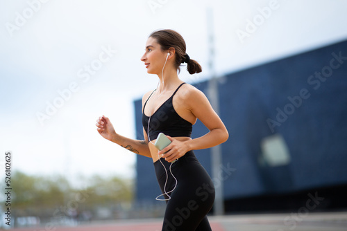 Sportswoman jogging outside in morning