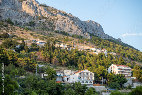 Rows of houses built on the steep slopes of Dinara mountain and its rocky cliffs towering over the village © Miroslav Posavec