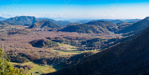 Panoramic view of volcanoes and autumn forest in La Garrotxa, Catalonia, Spain photo