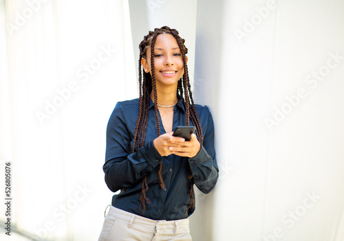 Portrait of beautiful young african woman with her cellphone