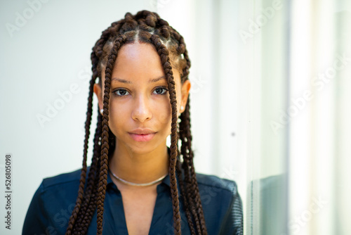 Close up of beautiful young african woman with braided hairstyle