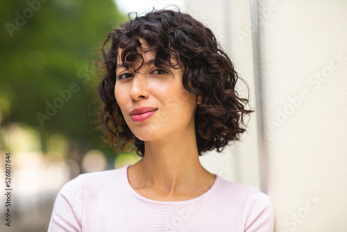Happy young woman with short curly hair photo