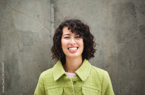 Portrait of cheerful young woman in stylish jacket