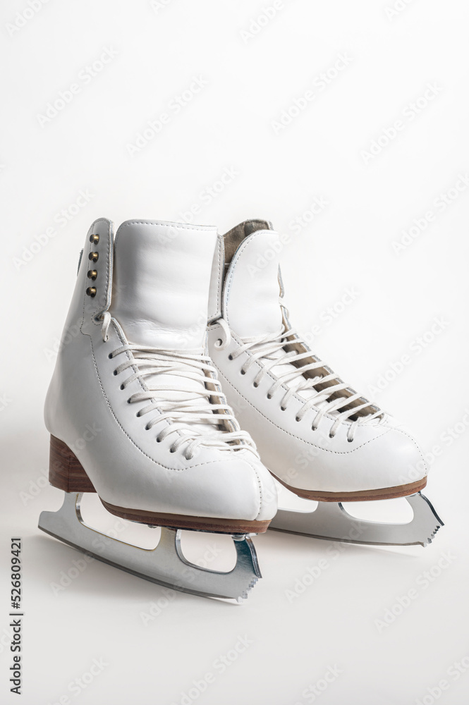 A pair of women's figure skates on a white background.