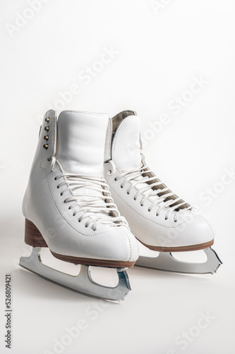 A pair of women's figure skates on a white background.