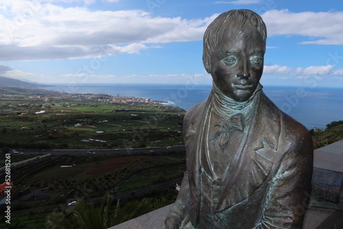 Fototapeta La Orotava, Tenerife, Spain, February 23, 2022: Bust of the German naturalist Alexander Von Humboldt at the Humboldt viewpoint with the Atlantic Ocean in the background