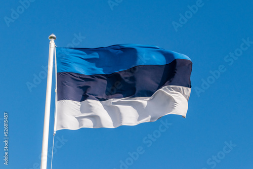 National flag of Estonia on blue sky. photo