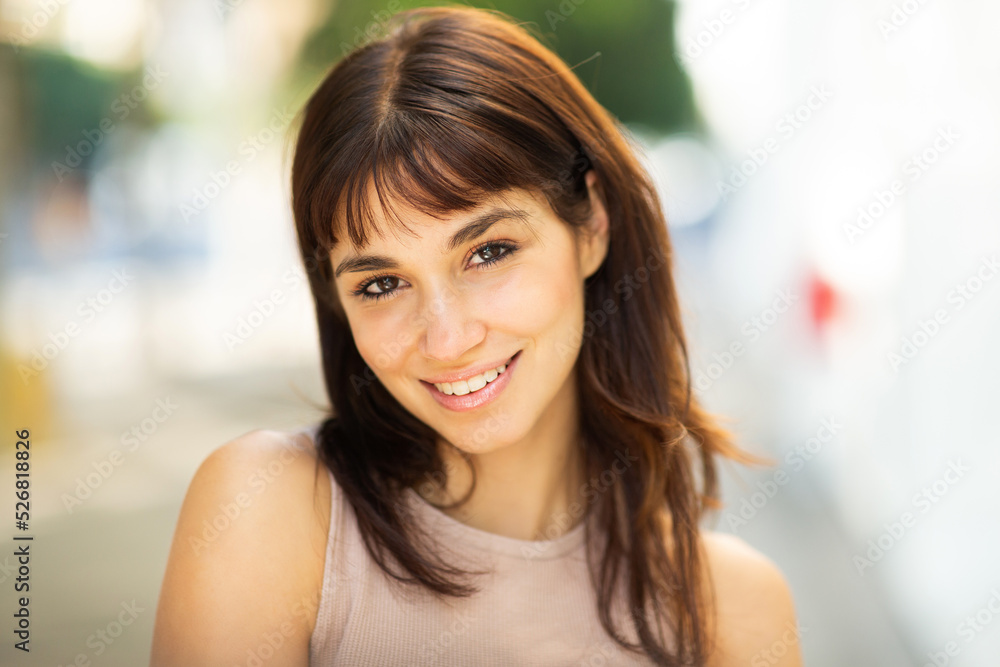 Pretty young woman standing outside