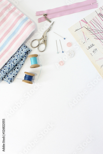 Φωτογραφία tailor workspace with sewing and handmade tools white desk background top view m
