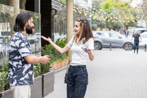 Young girl meeting her boyfriend at the street and feeling happy