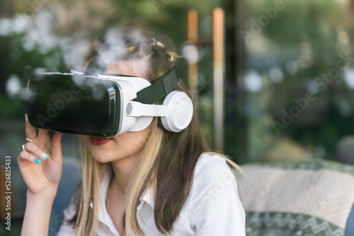 Photo of young lady wearing VR set photo