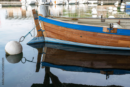 A wooden boat moored in a harbour on Lake Geneva 