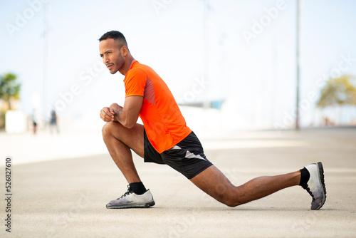 Fit man stretching outdoors in morning