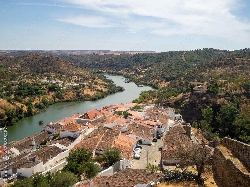 General view of Mertola inner castle walls housing seen from the Castle Tower and with Guadiana River and Alentejo hills
