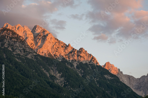 The Alpine landscape at dusk near Kranjska Gora in the Upper Carniola region of north west Slovenia. The mountain peaks from left to right - Rusica, Rigljica, Rusa Pec, Spik, Frdamane Police, 