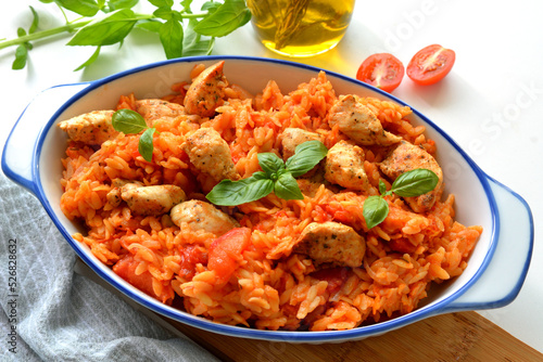 Kritharaki with tomatoes and chicken. Traditional type of Greek pasta shape of rice. Greek version of Italian Orzo